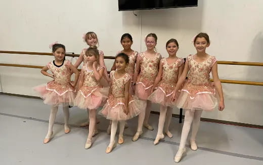 a group of girls in dresses