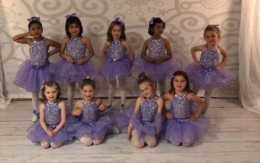 a group of girls in dresses