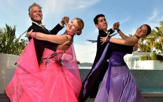 a group of people in dresses posing for the camera