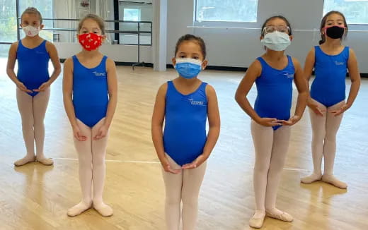 a group of women wearing blue dresses
