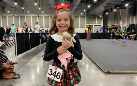 a girl holding a stuffed animal