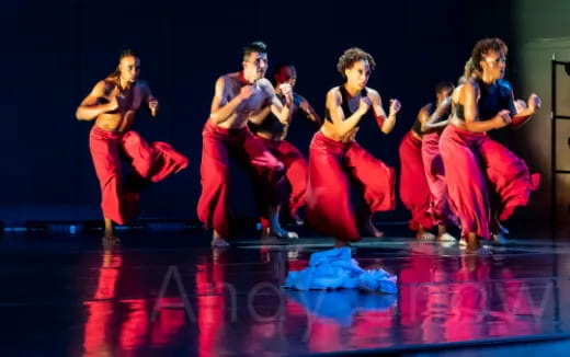 a group of people dancing on a stage