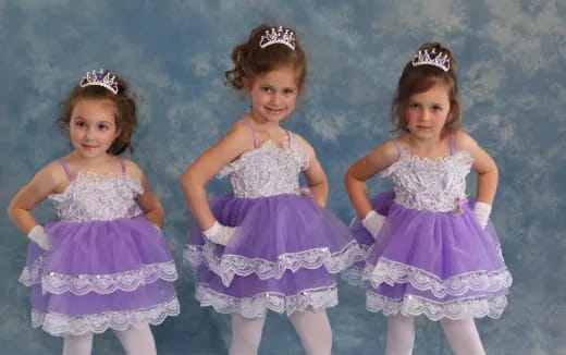 a group of girls in dresses