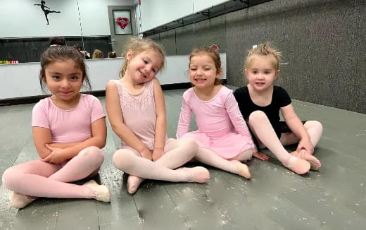 a group of girls sitting in a pool