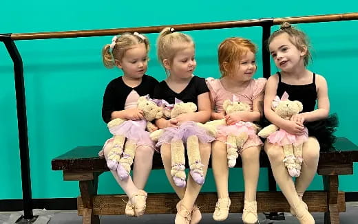 a group of children sitting on a bench