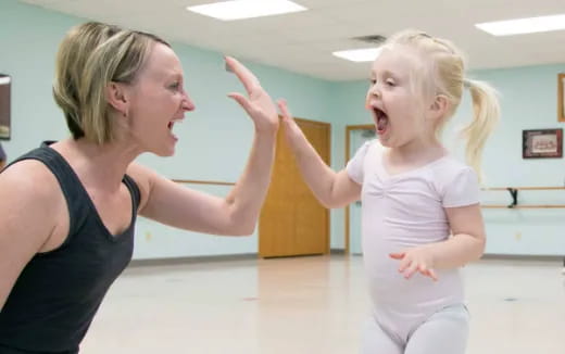 a woman and a girl dancing