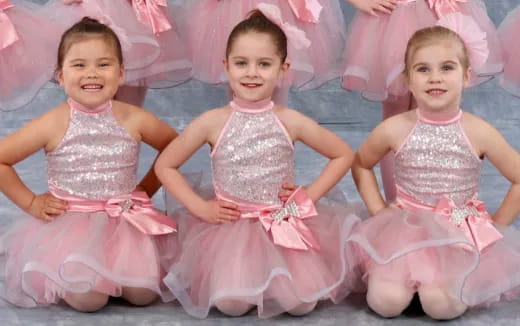a group of girls in dresses