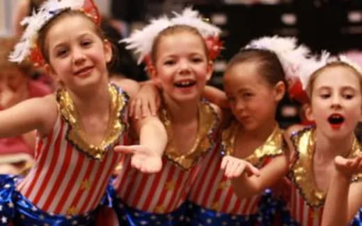 a group of women wearing colorful dresses