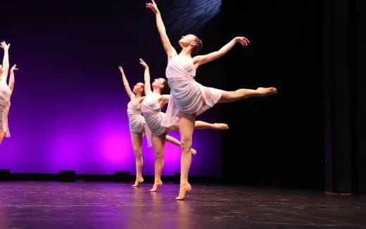 a group of people dancing on a stage