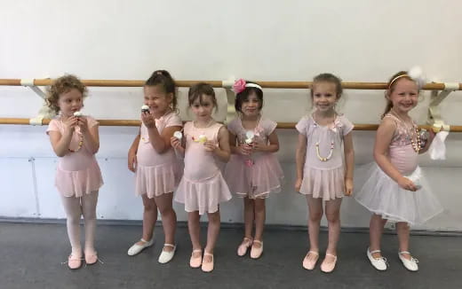 a group of girls in dresses