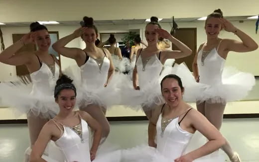 a group of women in white dresses
