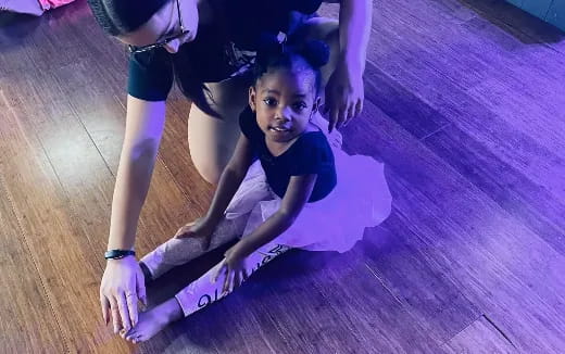 a person doing a handstand on a wood floor