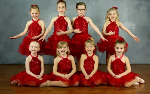 a group of people in red dresses