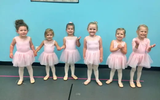 a group of girls in dresses