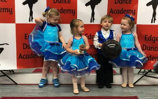 a group of girls in blue dresses