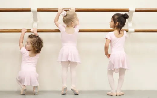 a group of girls in white dresses