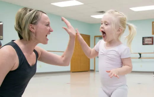 a woman and a girl dancing
