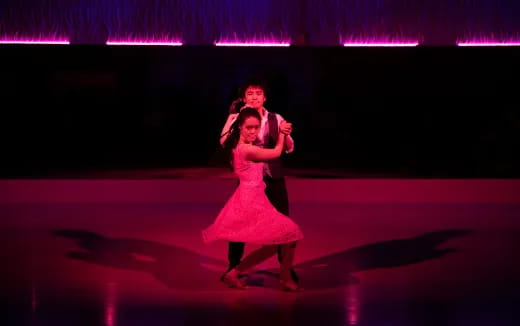 a man and woman dancing on a stage