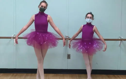 two women in leotards