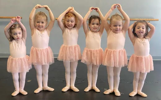 a group of girls in dresses