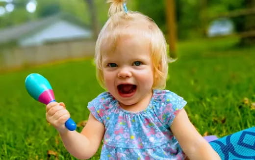 a baby holding a toy