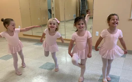 a group of girls in dresses dancing