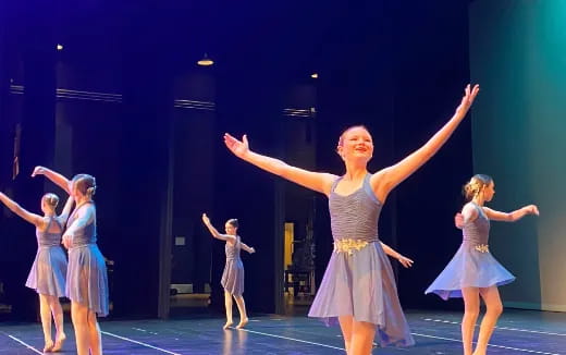 a group of people dancing on a stage