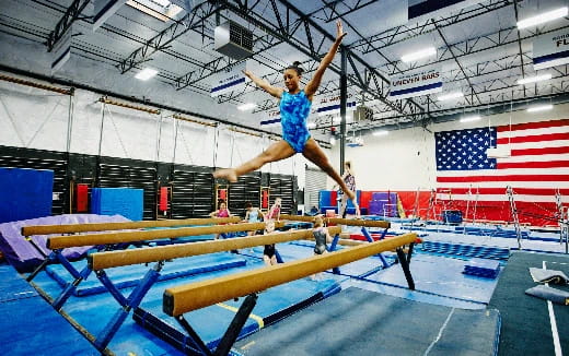 a person jumping over a bar