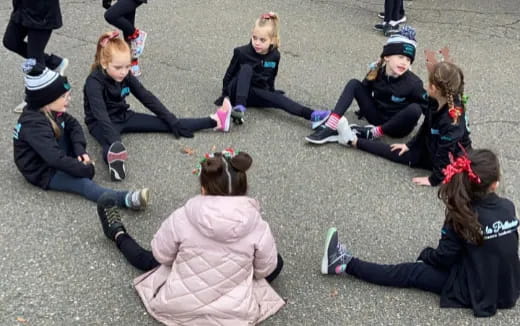 a group of girls kneeling on the ground