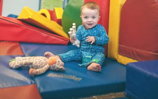 a baby sitting on a slide