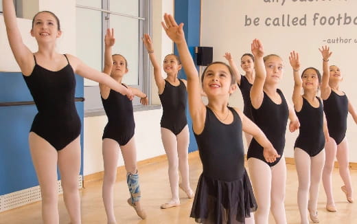 a group of women in black dresses
