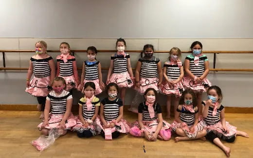 a group of girls wearing matching outfits