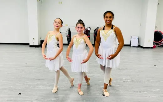 a group of women in white dresses