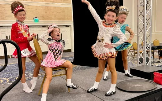 a group of girls in dresses