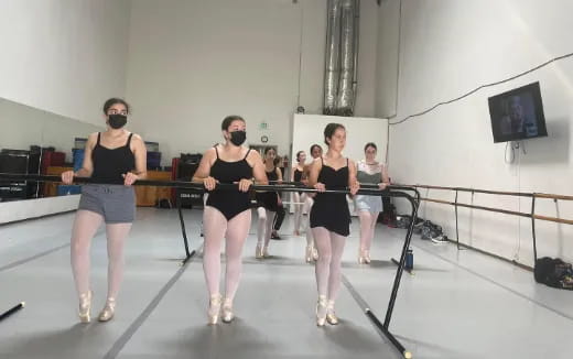 a group of women wearing black and white outfits