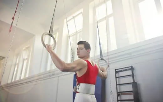 a woman in a red vest holding a light sword