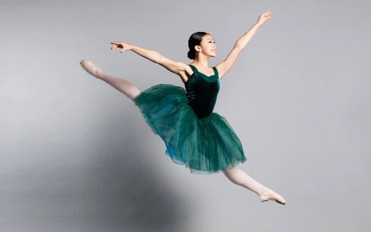 a woman dancing in a green dress