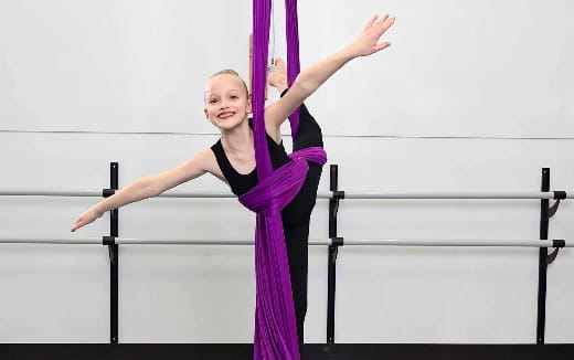 a woman in a leotard doing a handstand
