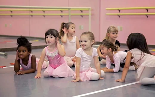 a group of girls sitting on the floor