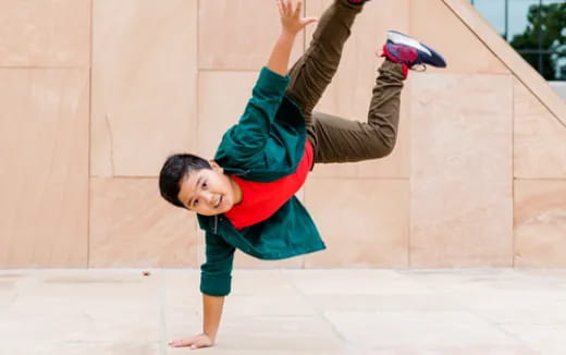 a boy doing a handstand