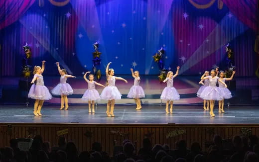 a group of girls performing on a stage