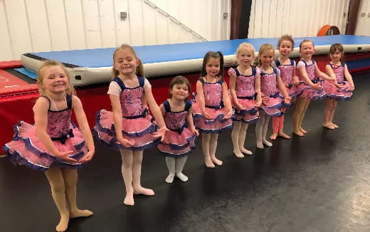 a group of girls in dresses