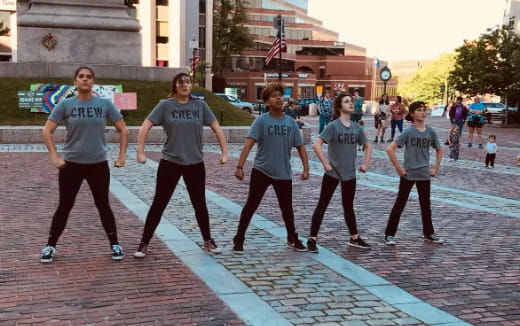 a group of people running on a brick road