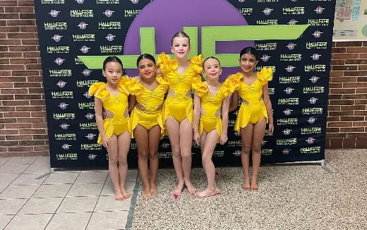 a group of girls in yellow uniforms
