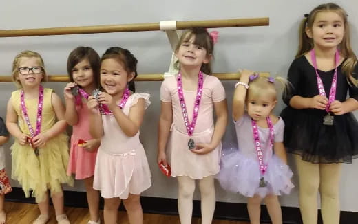 a group of girls in dresses
