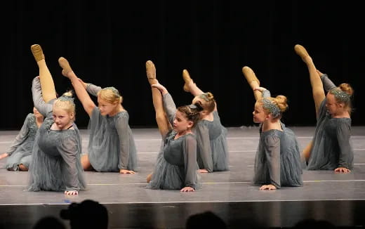 a group of children performing on a stage