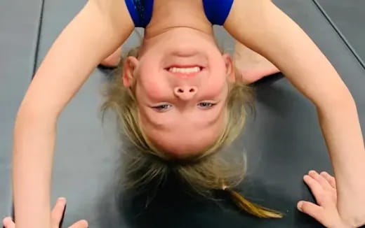 a girl with her hands on her head