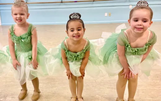 a group of girls in green dresses