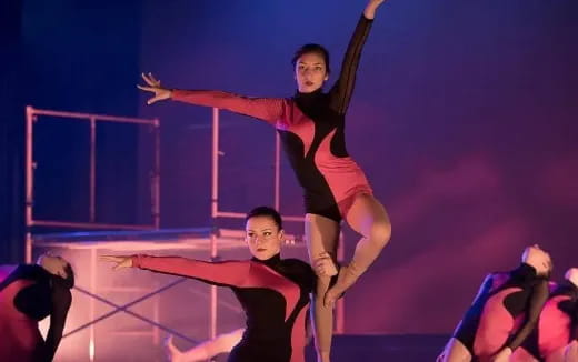 a woman holding a man's hand in the air