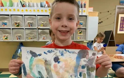 a boy holding a book